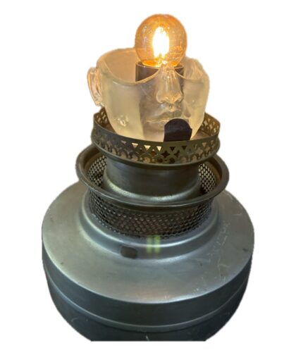 Table light made from a vintage oil lamp, with a resin head on the base.