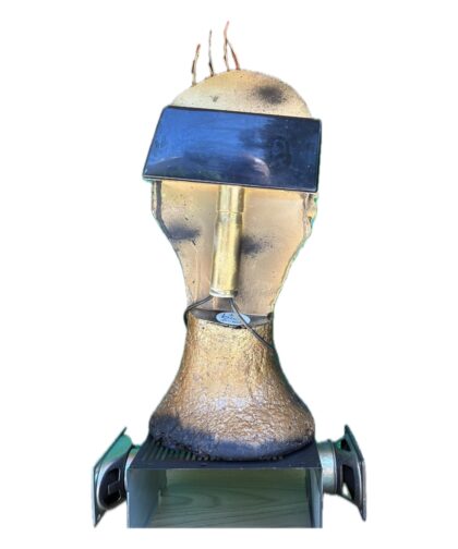 Lamp made from a foam head with LED lighting, magnets, and wires on top.