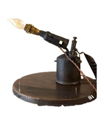 Vintage blowtorch with a lamp and fabric-covered cord.