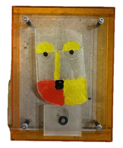 Plexiglass frame with a decorative resin sculpture.