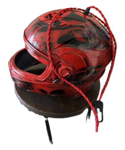 Helmet with internal lamp and fabric-covered cord.